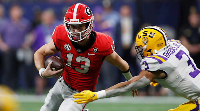 Georgia quarterback Stetson Bennett (13) moves the rock during the first half of the SEC Championship NCAA college football game between LSU and Georgia in Atlanta, on Saturday, Dec. 3, 2022.